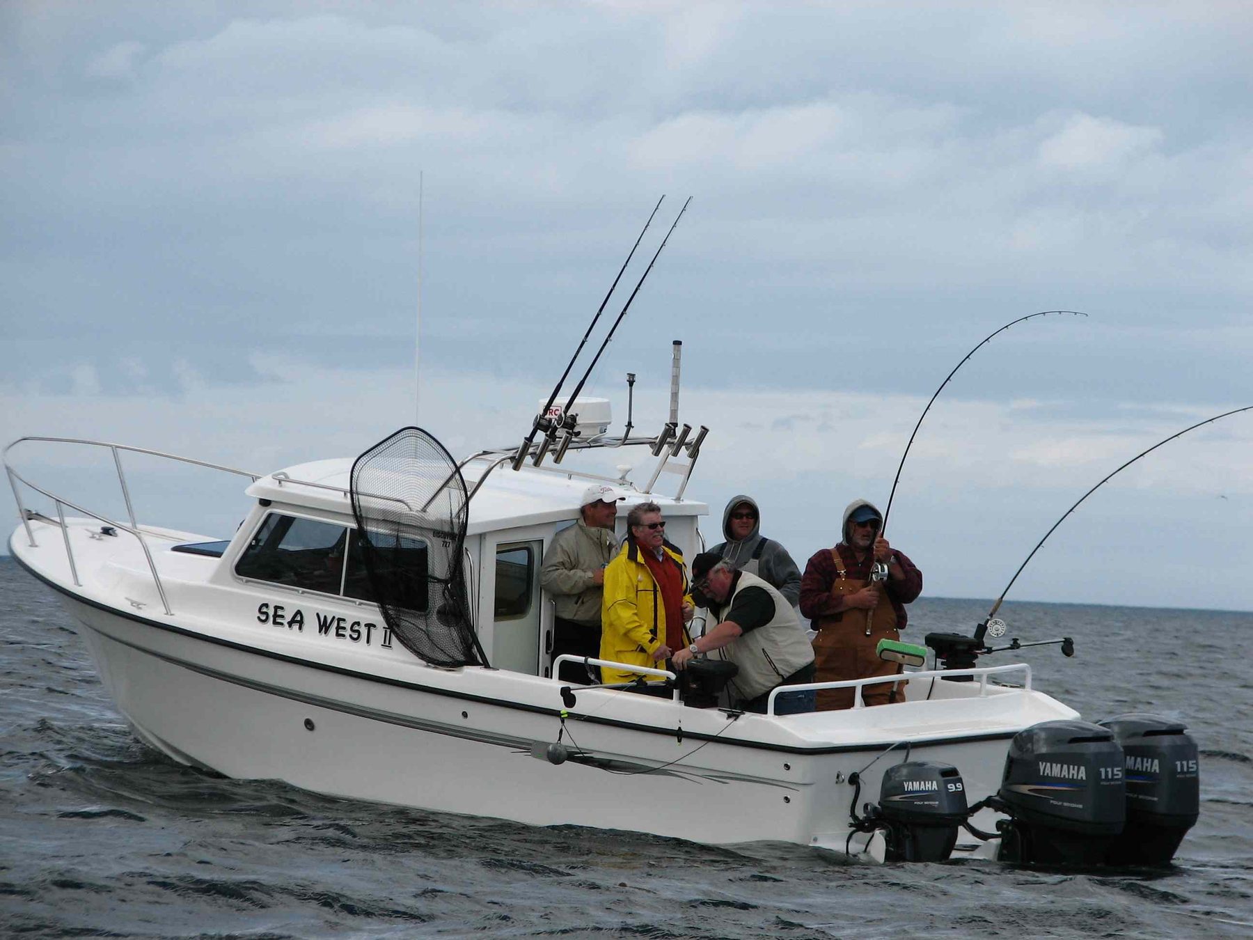 Sea West charter boat with anglers and rods off Masset